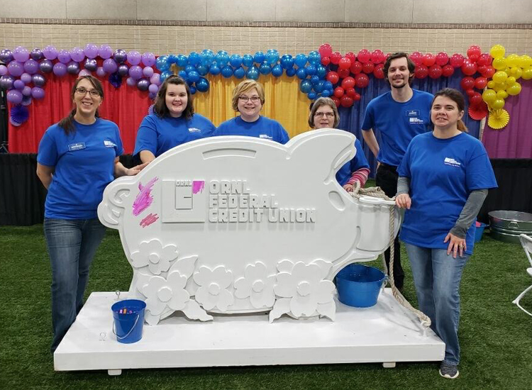 ORNL FCU volunteers with painted piggy bank
